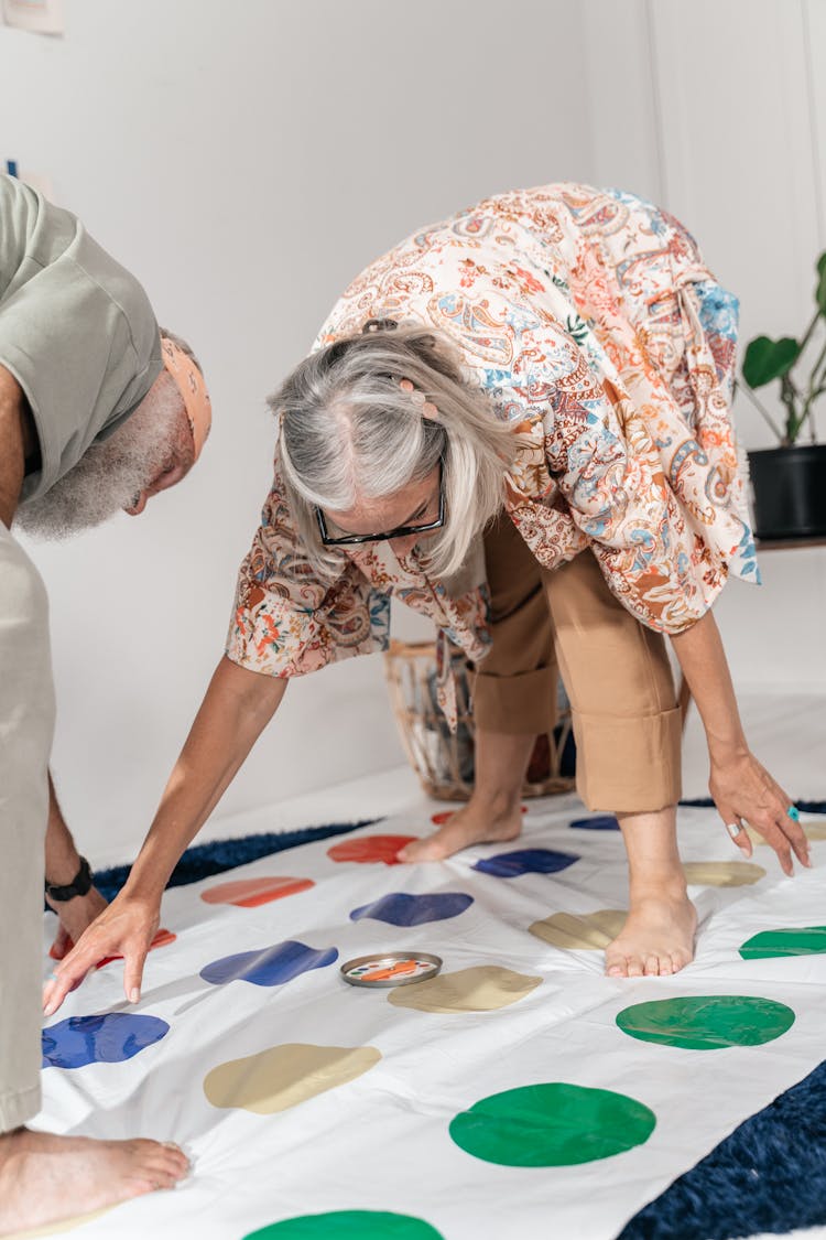 Active Elderly Couple Playing Twister Game