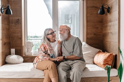 Free Senior couple enjoys a peaceful moment, sitting together in a warm, cozy indoor setting. Stock Photo