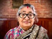 Woman in Black Framed Eyeglasses and Brown and White Scarf