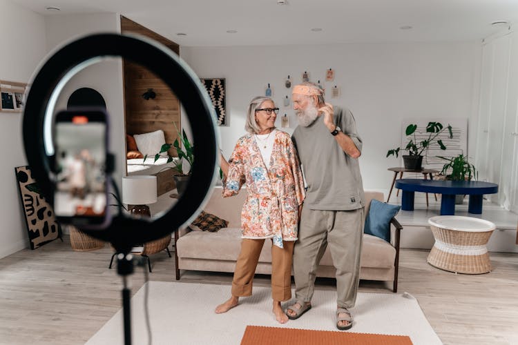 Old Cheerful Couple Recording Their Dance On Mobile Phone