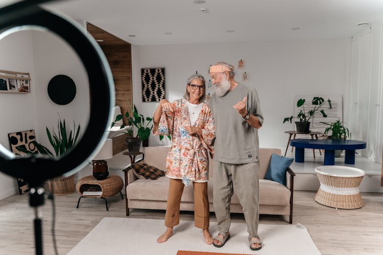 Senior Couple In A Living Room Wearing Pyjamas