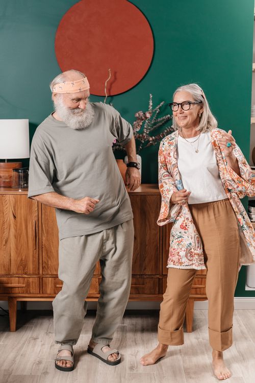 Free Elderly couple joyfully dancing indoors, symbolizing love and togetherness. Stock Photo