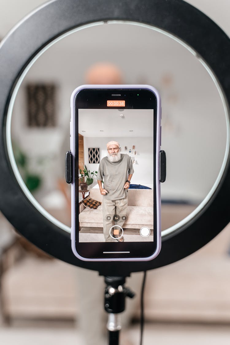 Elderly Man Making Video For Social Media Using Ring Light