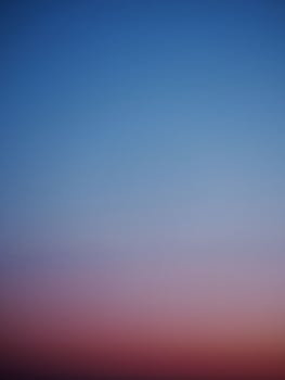 Peaceful twilight sky with a gradient of blue and pink hues creating an abstract visual.
