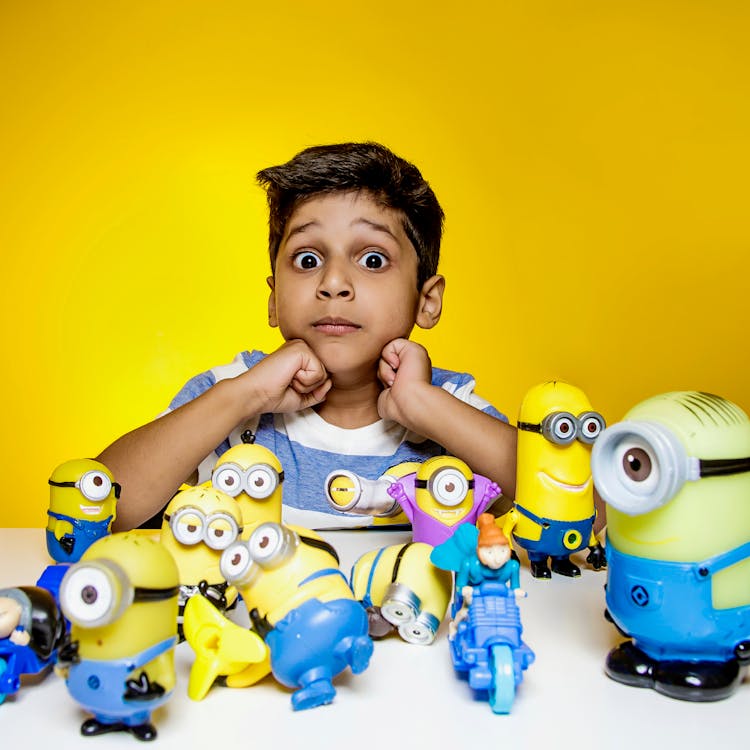 Photo Of A Boy With His Toys