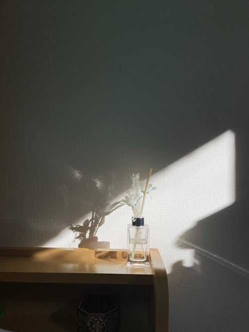 White Flowers on Glass Vase on Top of Wooden Table 