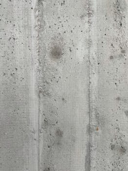 Detailed shot of a rough concrete wall texture, ideal for backgrounds.