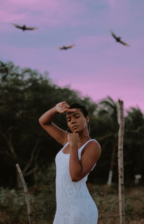 Free Serene portrait of a woman posing outdoors at sunset in Madre de Deus, Brazil. Stock Photo