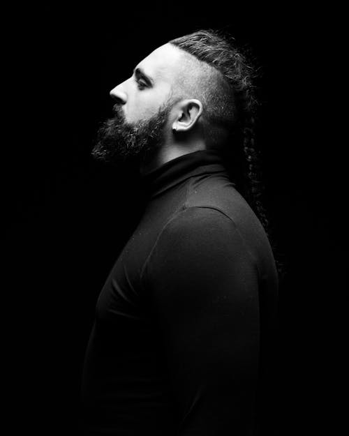 Black and White Photo of Man With Beard Wearing Long Sleeves 