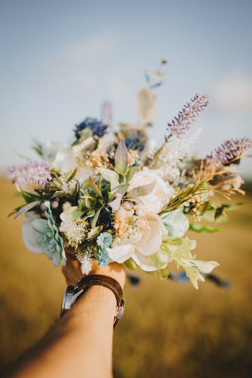 Selective Focus of a Person Holding Flowers