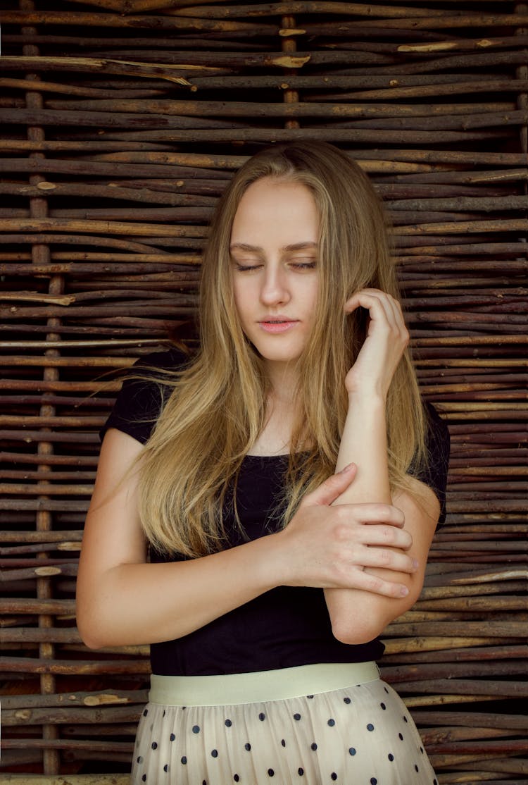 Woman With Beautiful Hair Holding Her Arm