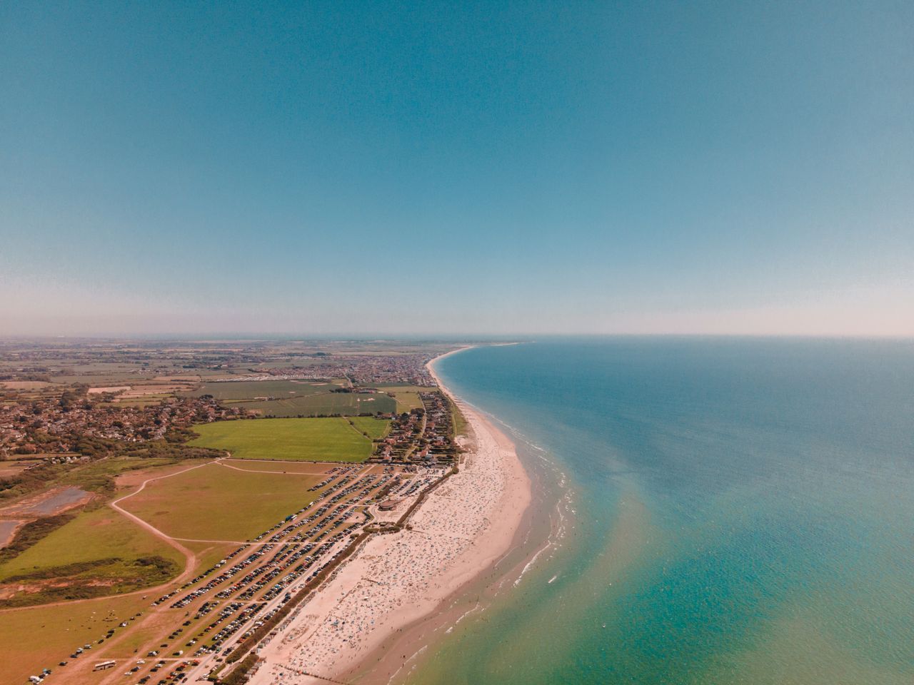 drone capture of west wittering s sandy beach meeting expansive englis