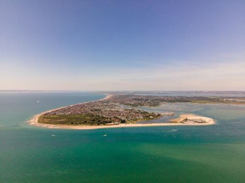Free Breathtaking aerial view of the West Wittering coastline in the UK, showcasing the vibrant sea and landscape. Stock Photo