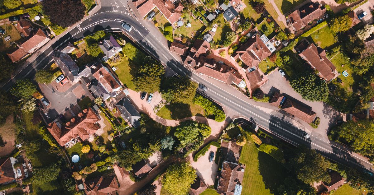 Aerial photo capturing the lush greenery and rooftops of Singleton, England on a sunny day.