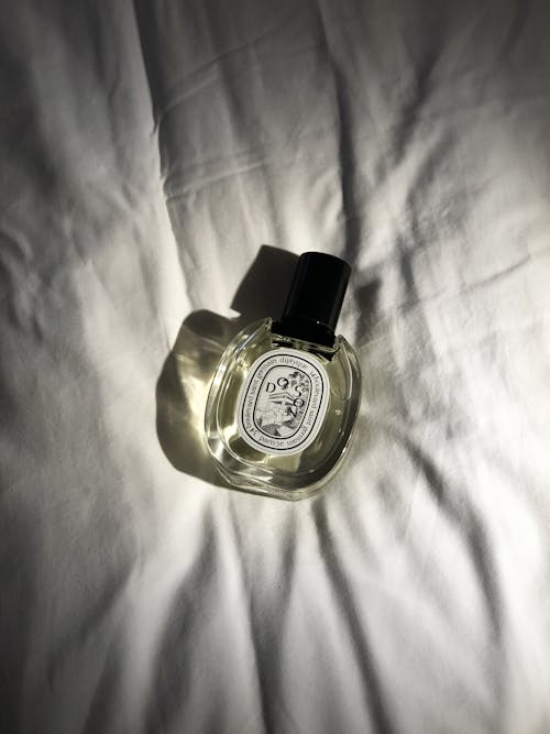 Free Perfume Bottle on White Cloth Stock Photo