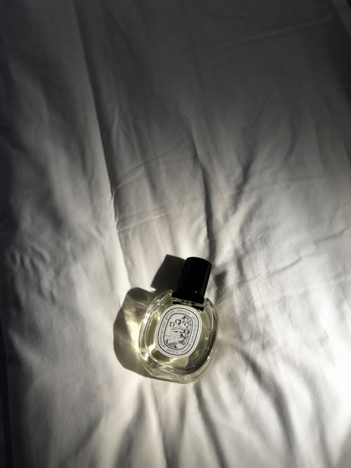Perfume Bottle on a Bed