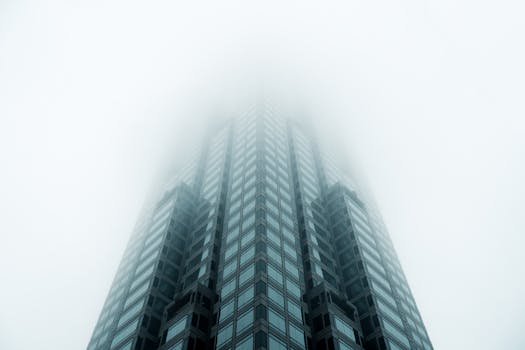 Low angle view of a modern skyscraper disappearing into fog in Atlanta, GA.