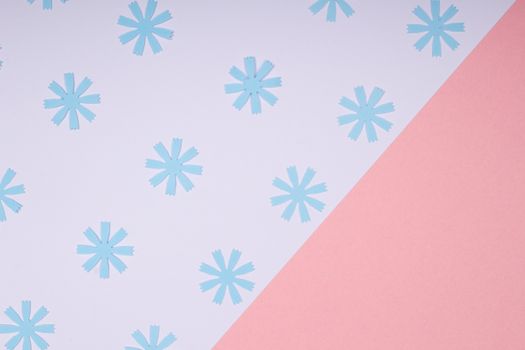 Modern abstract design featuring blue snowflake motifs on a pink and white background.