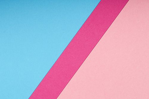 Free A minimalist abstract image featuring blue, pink, and magenta paper textures. Stock Photo