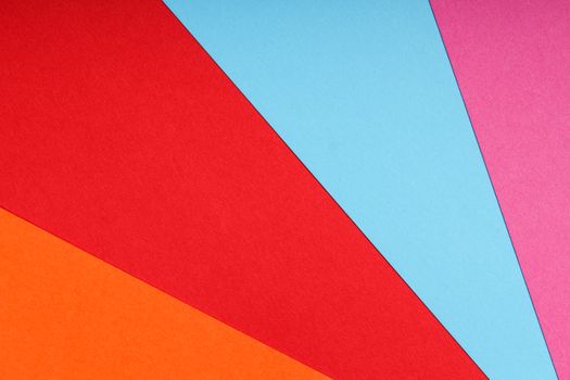 Vibrant geometric pattern with colorful paper sheets forming an abstract background.