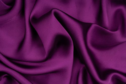 Free A detailed close-up of luxurious purple silk fabric with elegant folds and smooth texture. Stock Photo