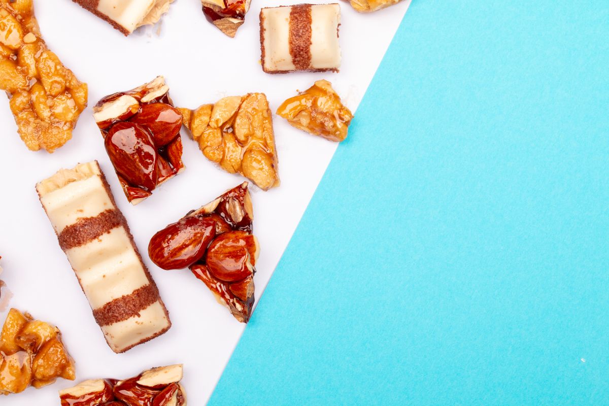 Variety of pastries and sweets with vibrant blue copy space for text.