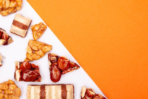 Caramelized Almonds and Nuts on Orange and White Surface