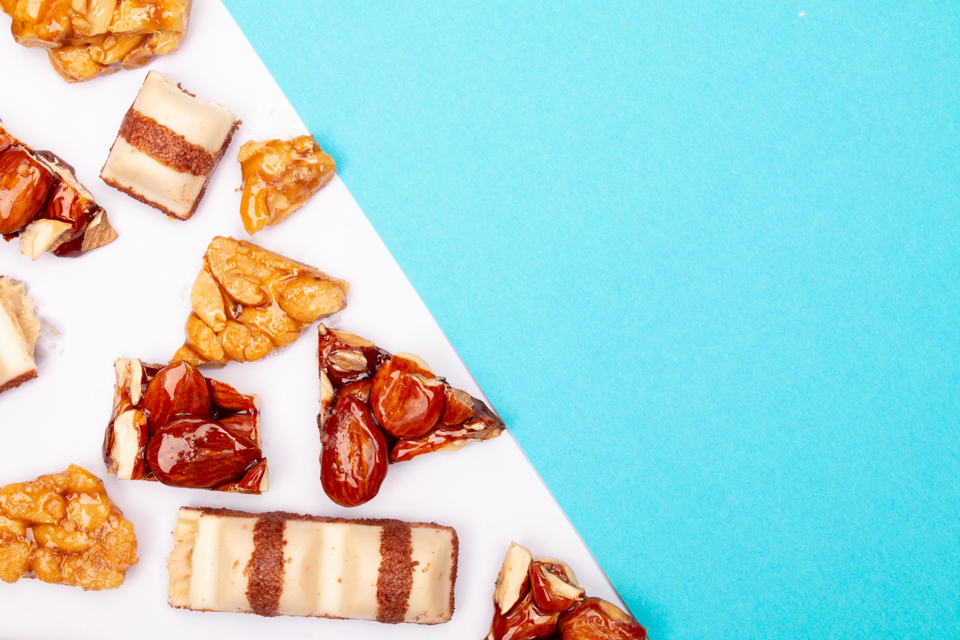 Chocolate drizzled nut clusters on baking sheet