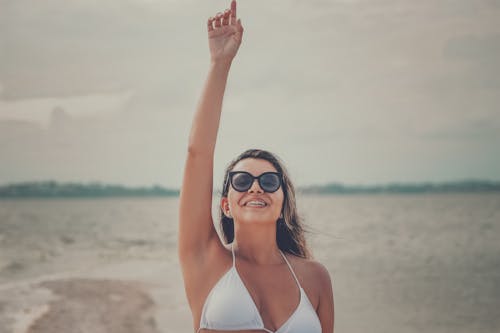 Free Smiling Woman in White Bikini Top Wearing Black Sunglasses Stock Photo