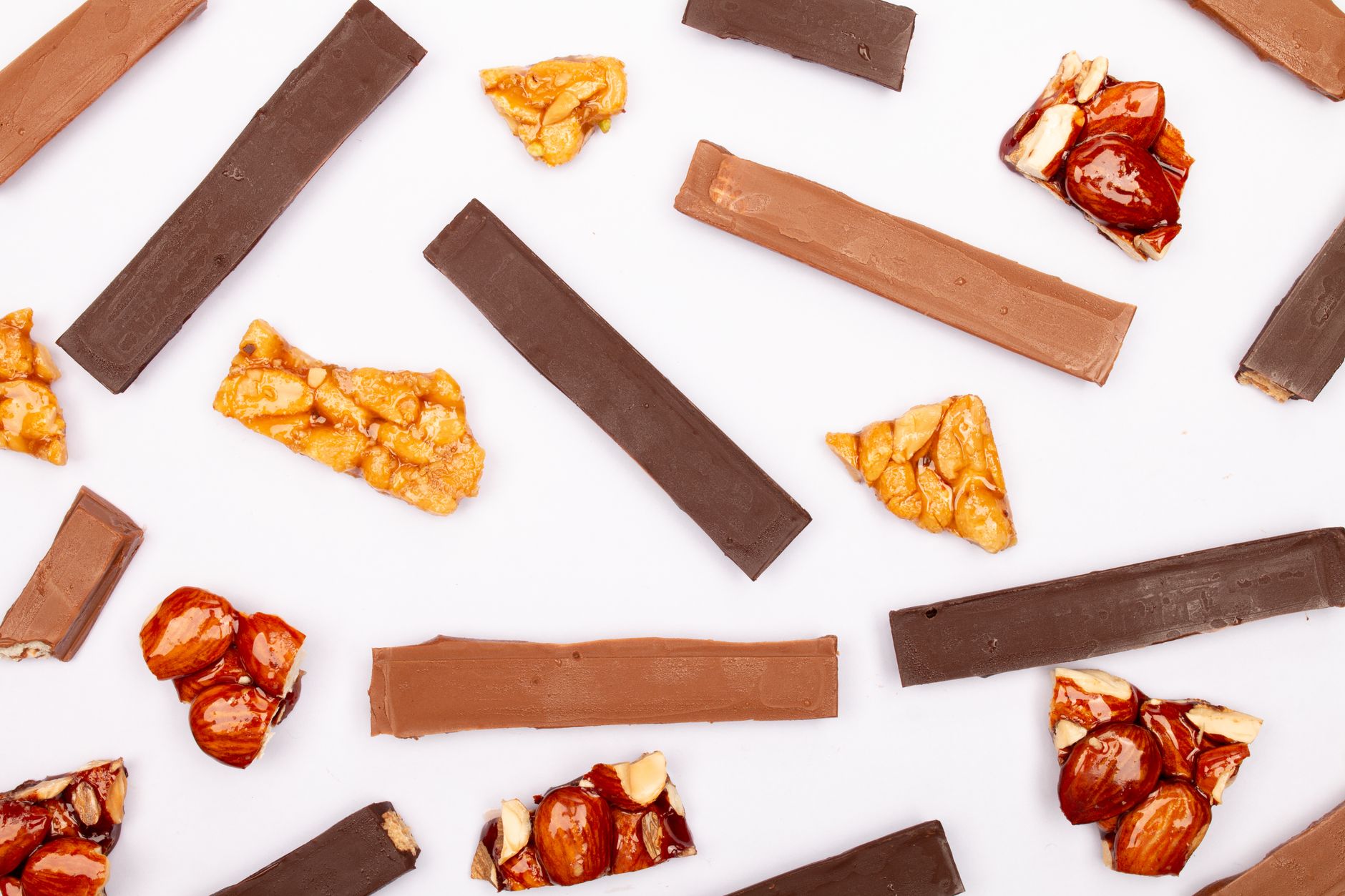 Chocolate-covered almond toffee bars on a plate with almonds