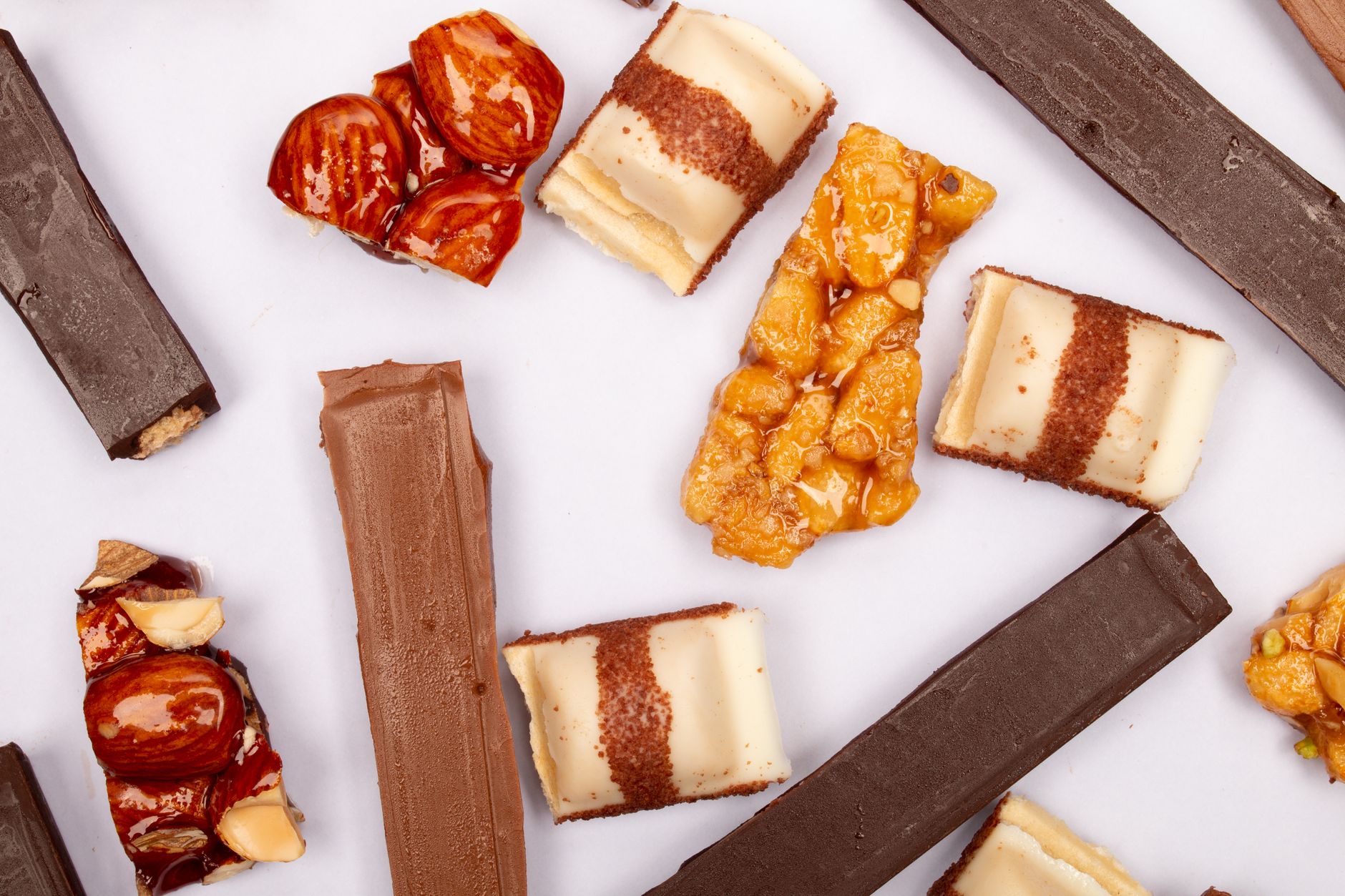 Top view of assorted chocolates with nuts, perfect for food photography enthusiasts.