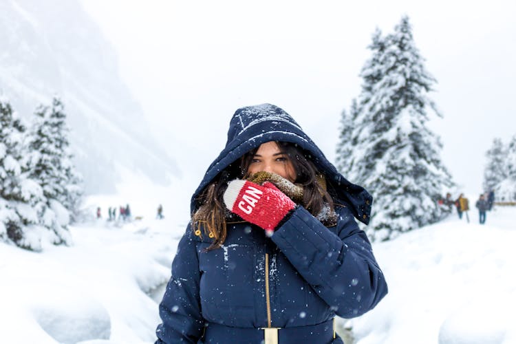 Woman In Blue Zip-up Hooded Jacket Standing On Snow