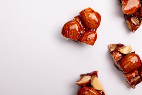 Glazed Brown Nuts on a White Surface