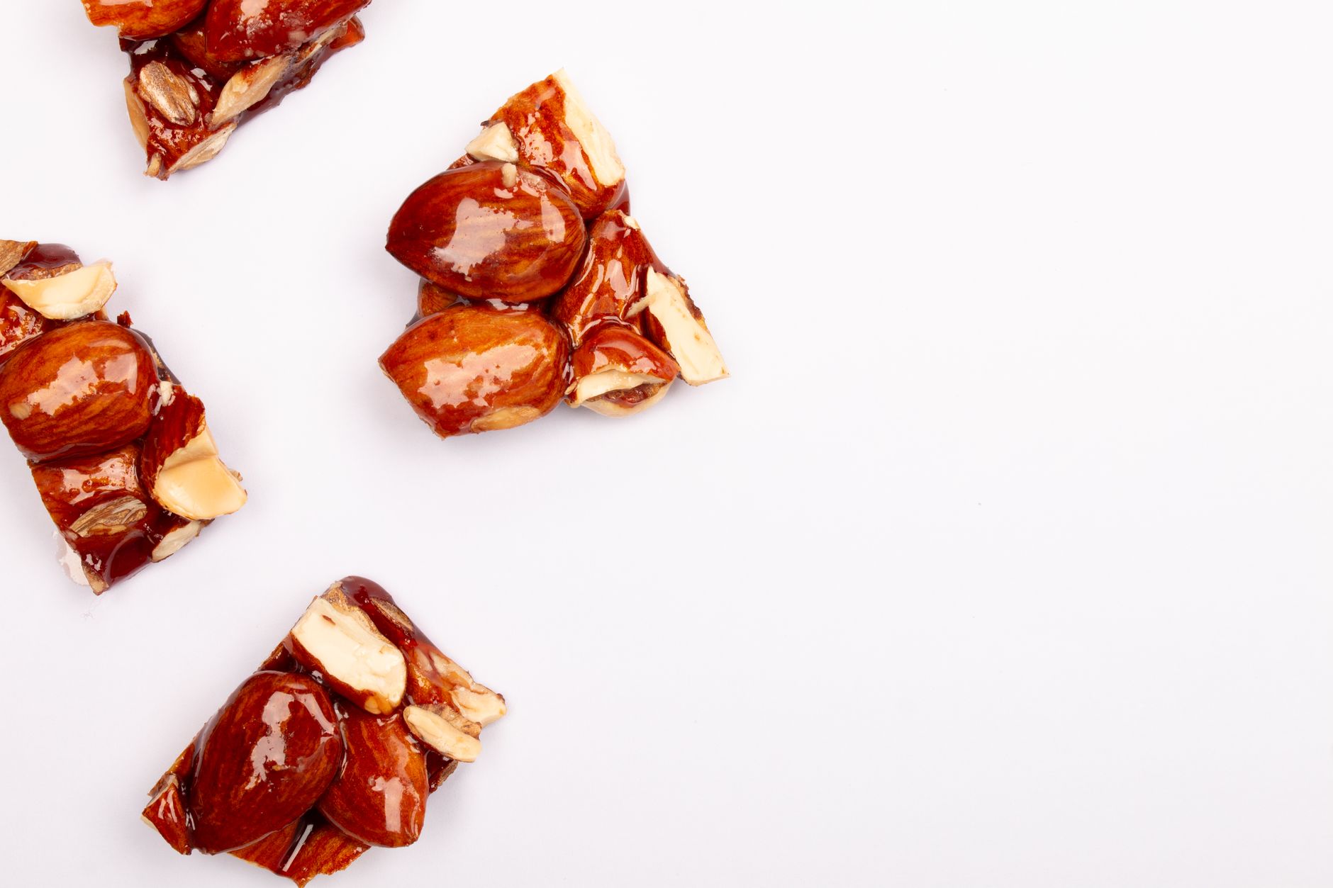 Golden peanut brittle pieces on a sheet