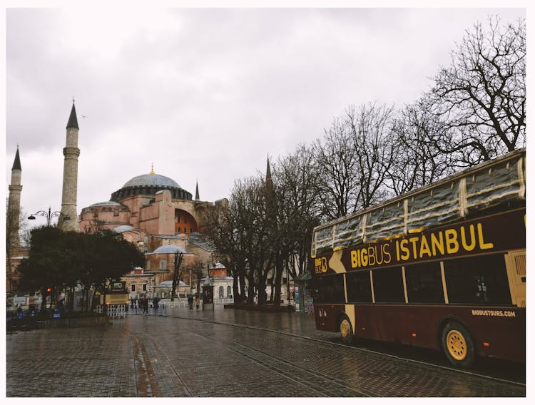 Brown Bigbus Istanbul Traveling On Road Near Brown Dome Building