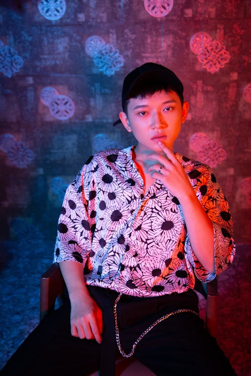 Man in a Floral Shirt Posing with His Hand on His Chin