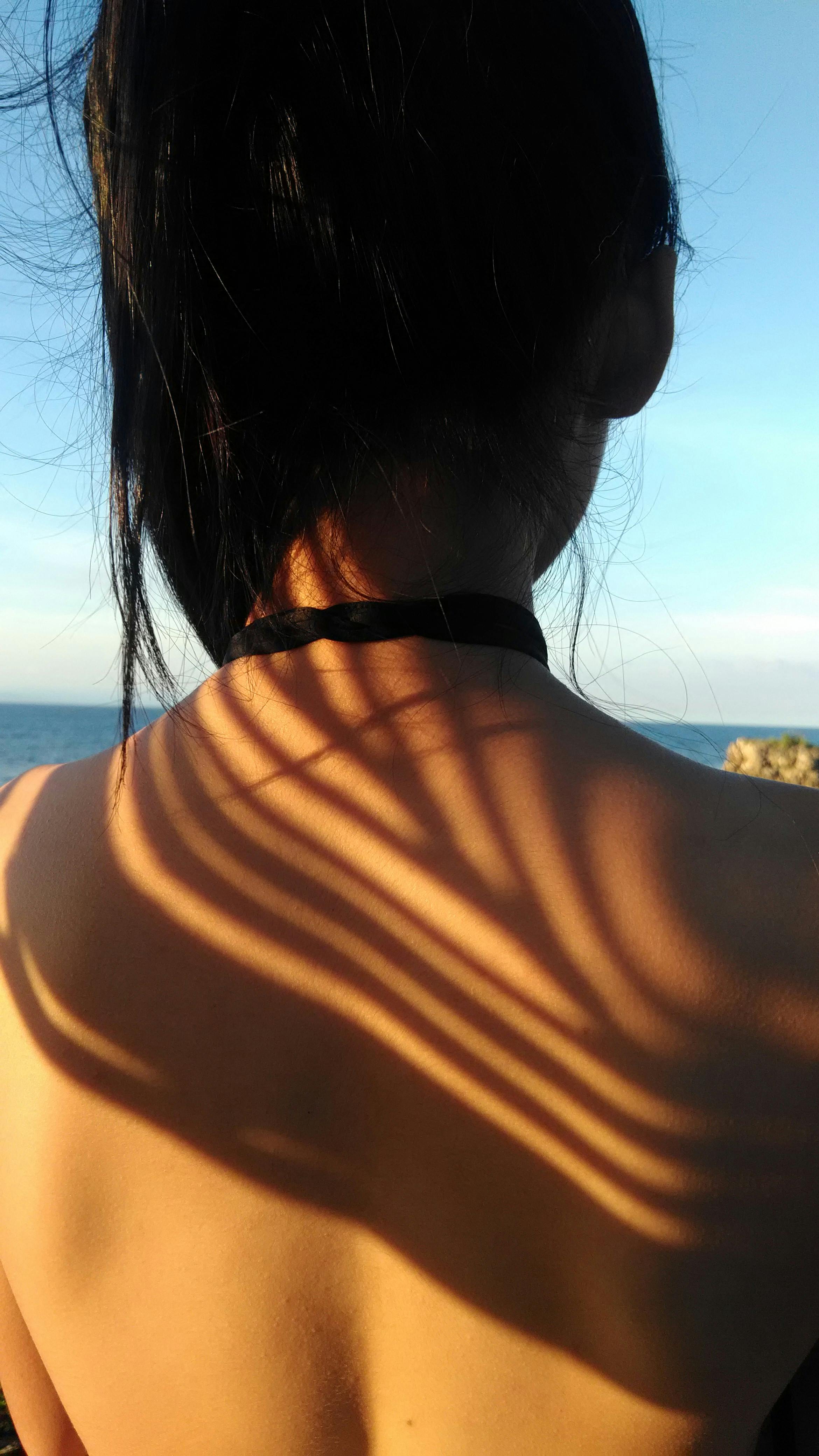 woman standing in front of body of water