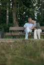 Couple Sitting on Brown Wooden Bench