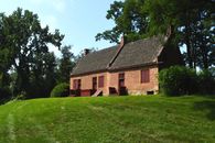 Brown Brick House Near Green Grass Field