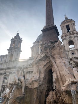 Low-angle Photo of Gray Concrete Building With Statues