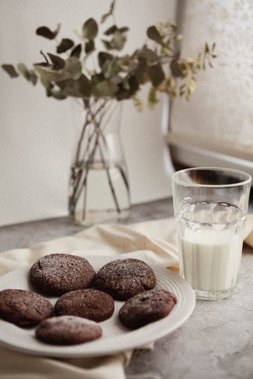 Clear Drinking Glass With Milk Beside A Plate Of Cookies