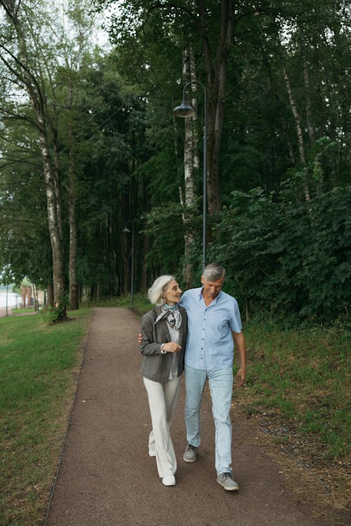 Elderly Couple Walking Together on a Pathway