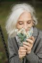 Woman in Gray Cardigan Holding Yellow Flower Bouquet