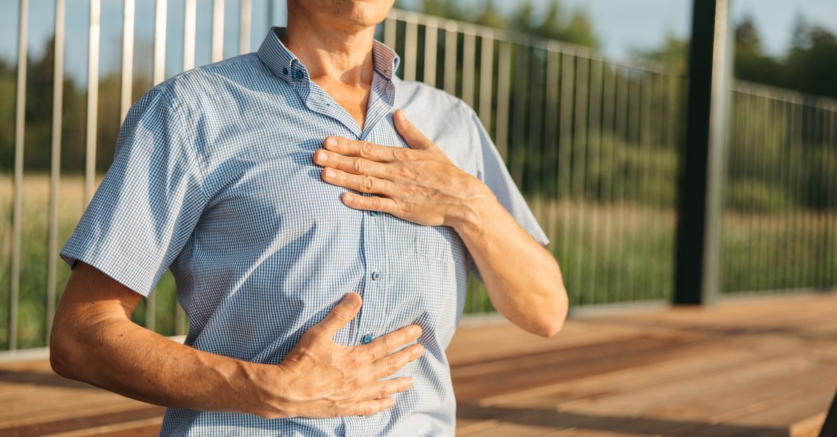 A person practicing relaxation with hands on chest and abdomen outdoors