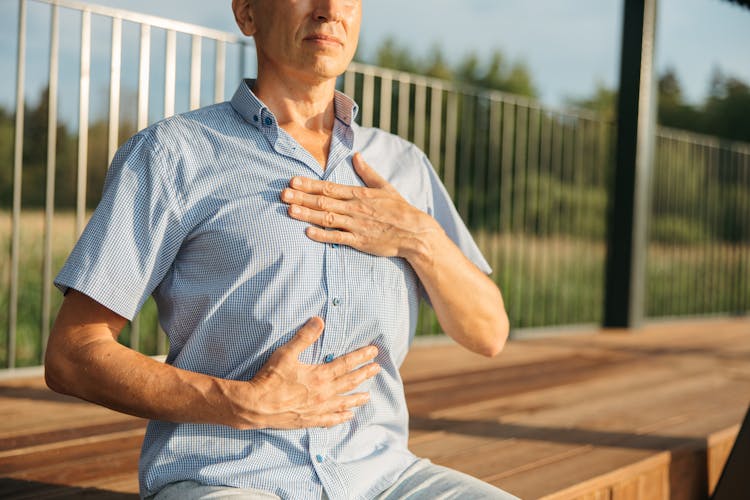 Person's Hands On His Chest 