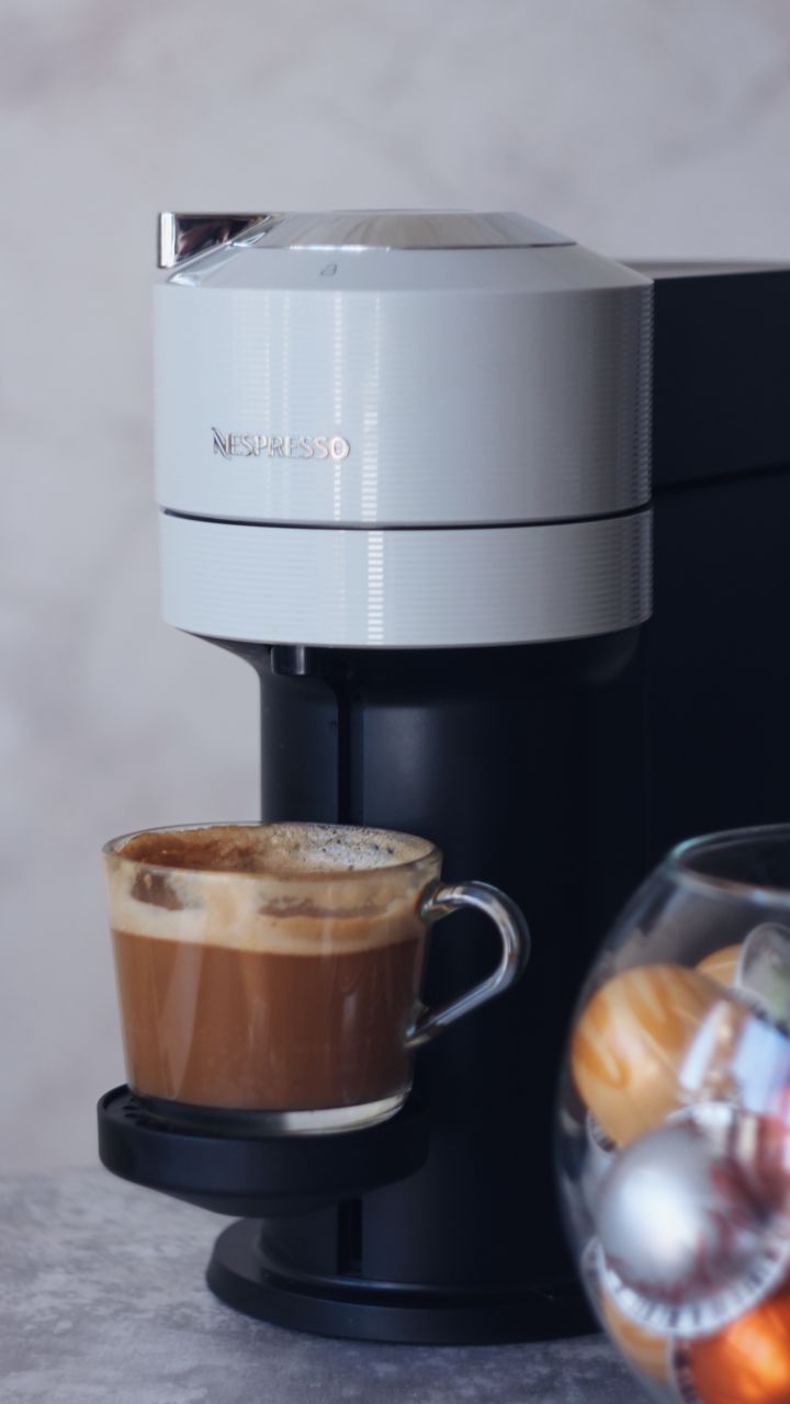 minimalist small corner coffee bar with just a single serve coffee maker and hanging mug