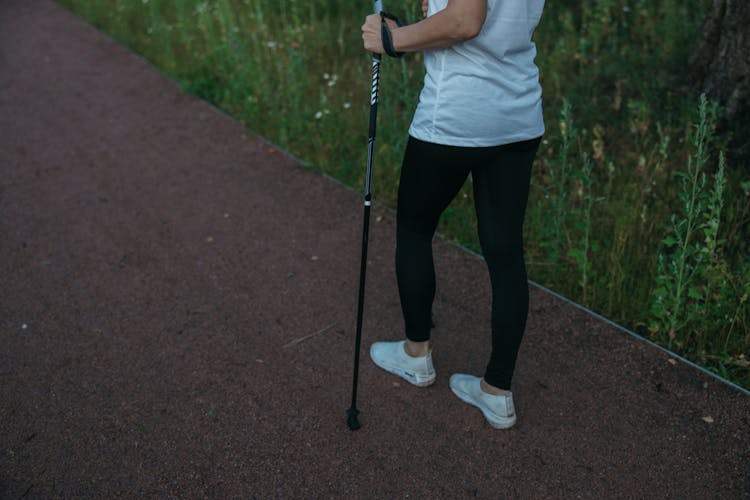 A Person With A Trekking Pole Walking