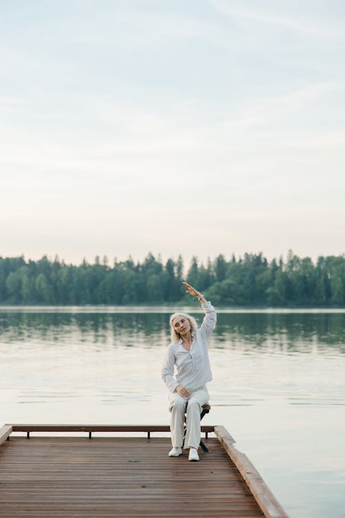 Free Woman in White Long Sleeve Shirt and White Pants Running on Water Stock Photo