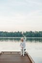 Woman in White Long Sleeve Shirt and White Pants Running on Water