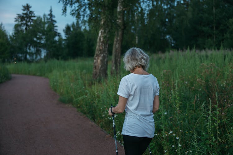 Elderly Woman Walking On A Park